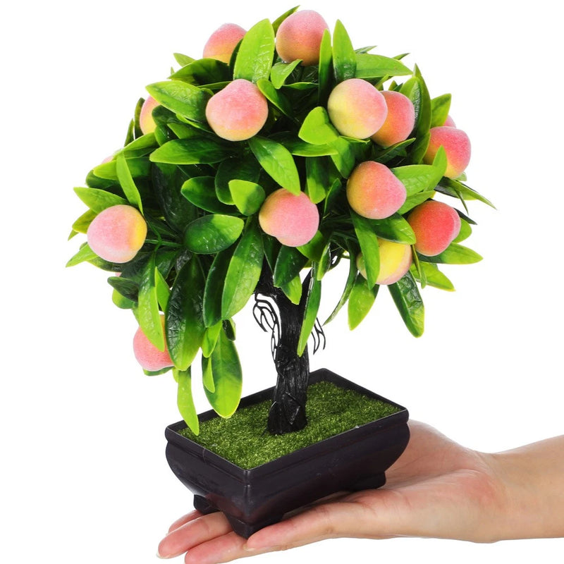 Artificial mini bonsai tree with green leaves and pink peach-style flowers in square pot