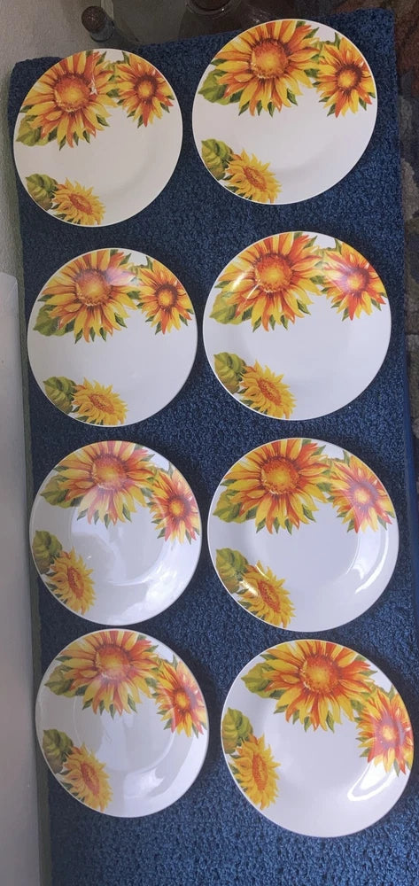 Set of 8 ceramic salad plates with white background and colorful sunflower print