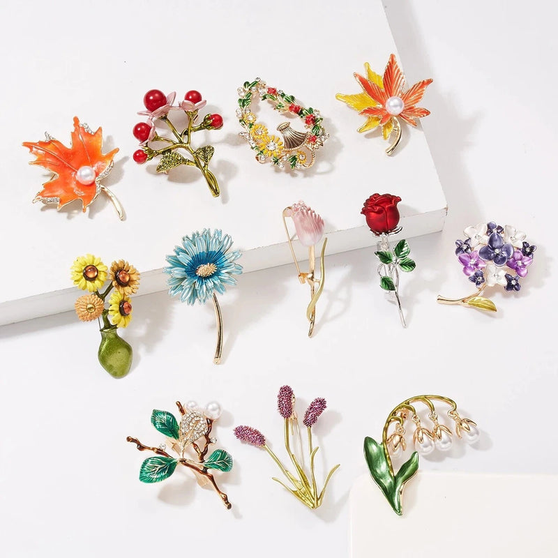 Assorted flower and leaf pearl brooch set with red, orange, blue, and purple accents