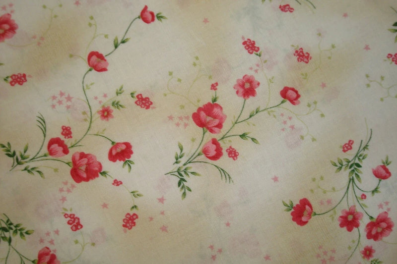 Cream cotton fabric with red and pink tonal carnation floral print