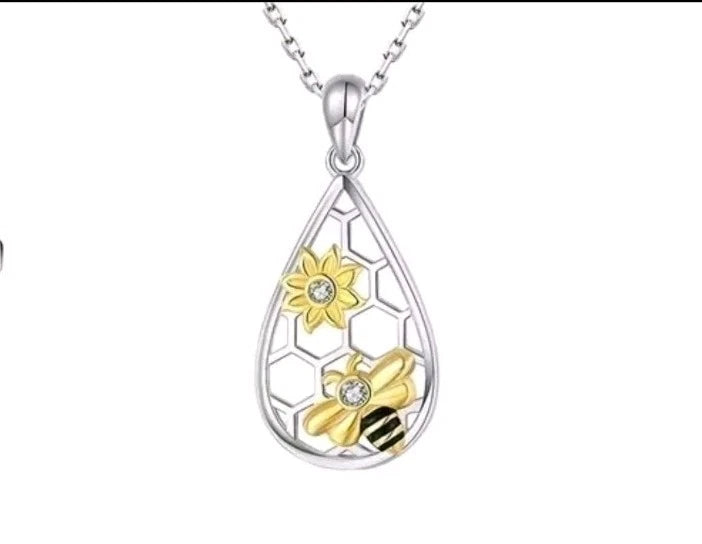 Silver-toned teardrop pendant necklace with yellow sunflower and clear crystal details
