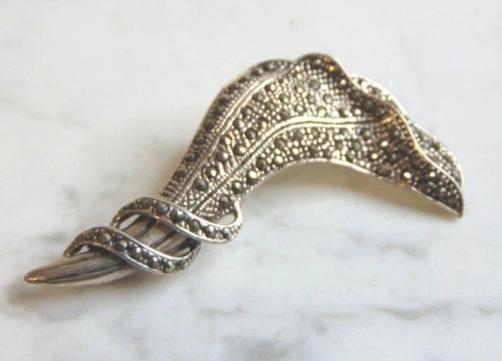 Vintage Art Deco lily flower brooch with openwork metal and dark marcasite accents