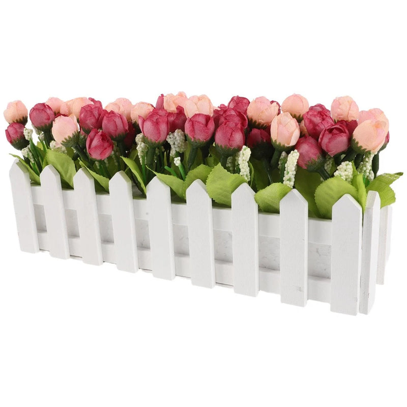 Artificial faux rose centerpiece in white picket fence planter with green leaves