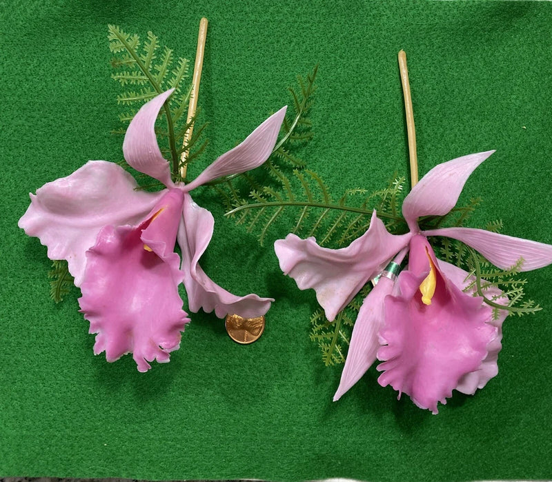 Pink plastic orchid rose stems with two blossoms, gold centers, and green leaves