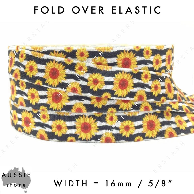 Fold over elastic trim with sunflower floral print on dark fabric, about 16 mm wide