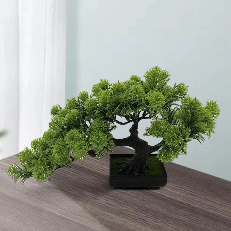 Artificial bonsai pine tree in square black pot with dense green foliage