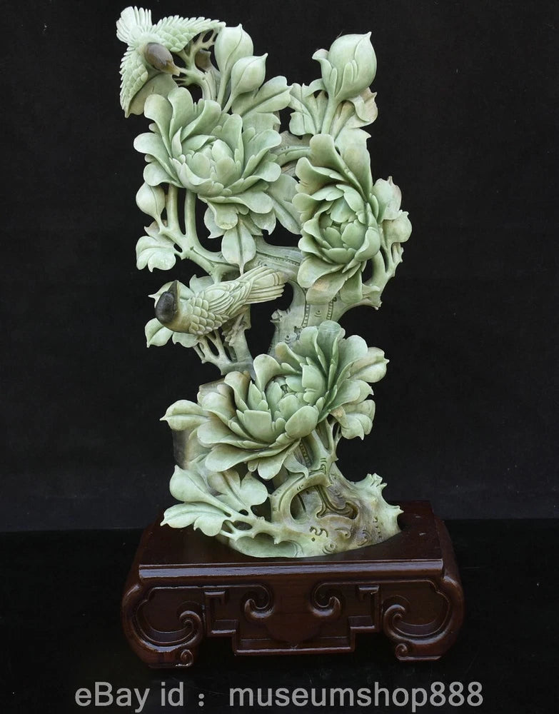 Carved jade peony flower and bird statue with ornate swirl base, pale green