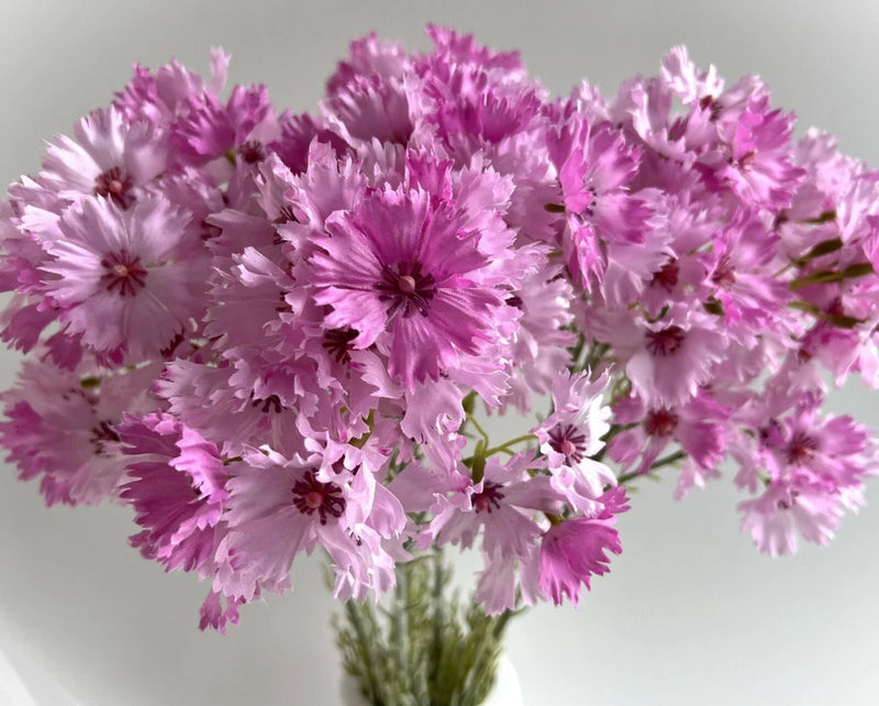 Pink faux silk carnation flower stem spray with clustered ruffled dianthus blossoms