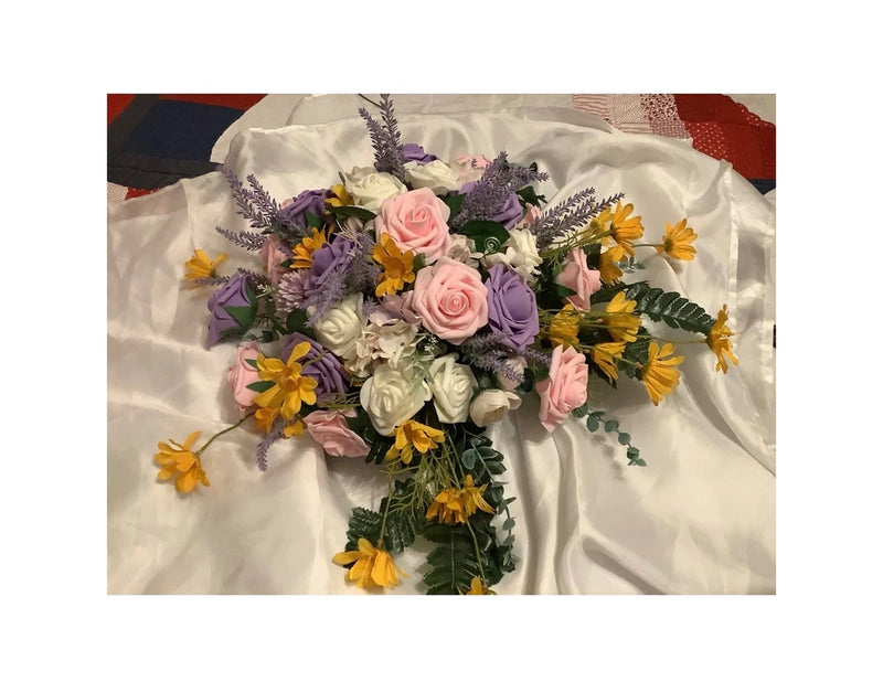 Customized bridal bouquet with pink roses, purple and white blooms, yellow accents and greenery