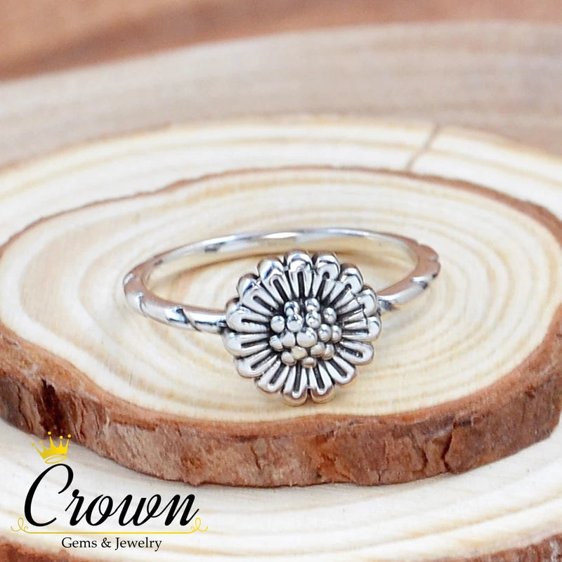 Sterling silver sunflower ring with raised flower center and petal-like edges