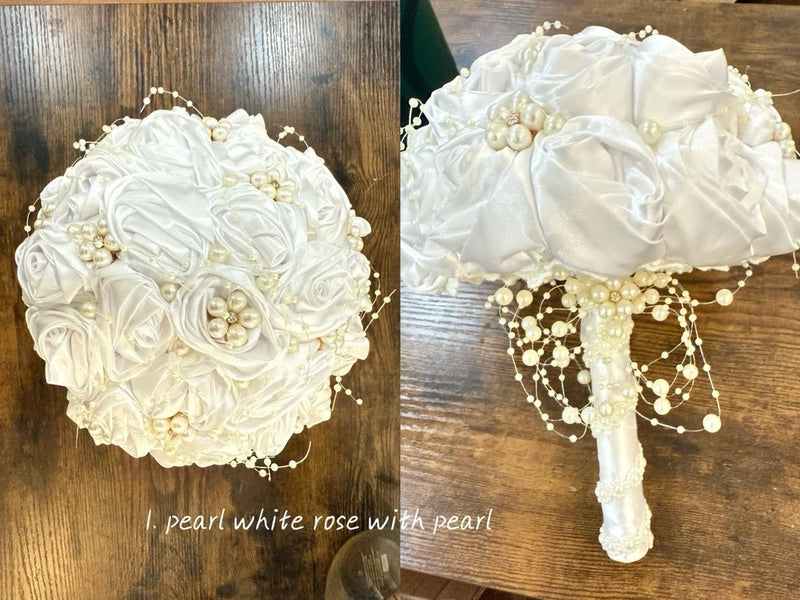 White artificial rose bouquet with faux pearls and dangling pearl bead strands, satin handle
