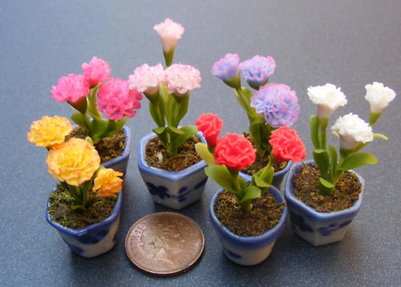 Mini carnation flowers in small ceramic pots, assorted colors with green stems