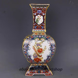 Ornate porcelain vase with gilded trim, peony floral and bird on four sides