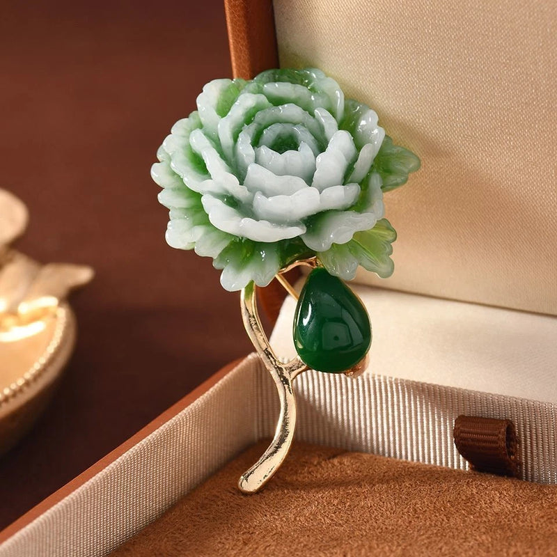 Green resin peony flower brooch pin with gold-tone curved base and leaf detail