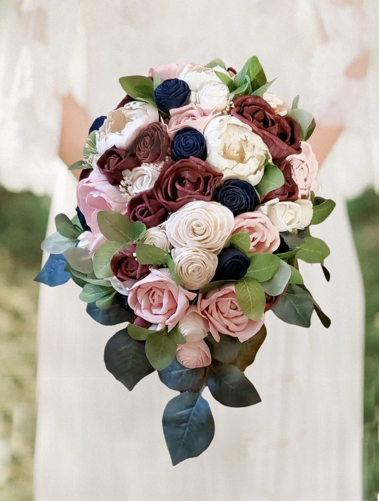 Bridal bouquet with cascading faux flowers in blush pink, burgundy, navy, and white