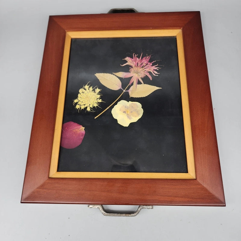 Wood-framed glass wall art with dried pressed flowers in a square yellow-pink arrangement