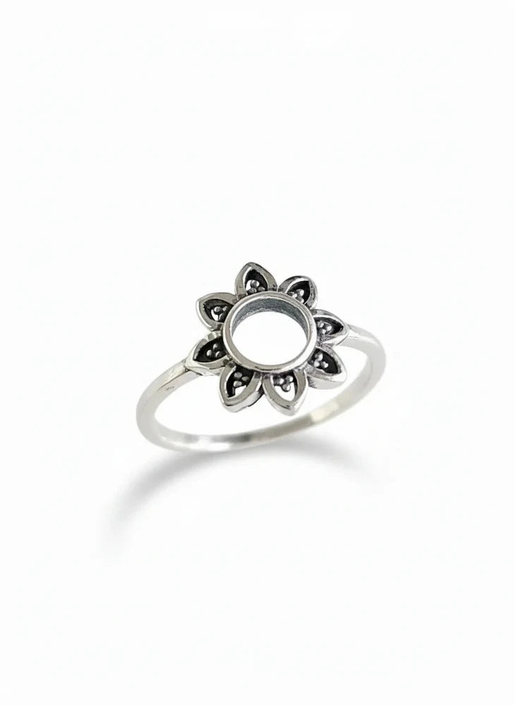 Sterling silver sunflower motif ring with raised flower center on a slim band