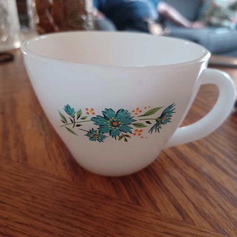 Vintage milk glass coffee cup with floral blue and orange print