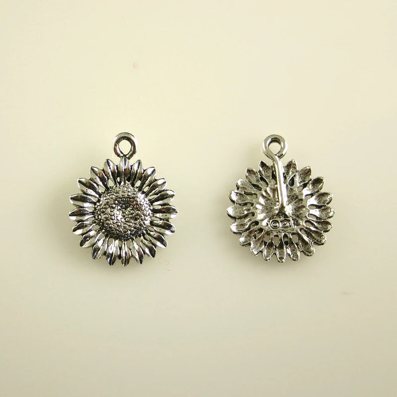 Pewter sunflower charm with hanging loop, detailed petals and textured center