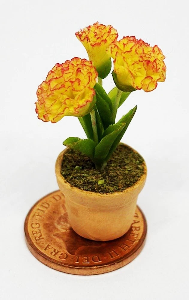 Dollhouse ceramic pot of red and yellow carnations with green stems and leaves