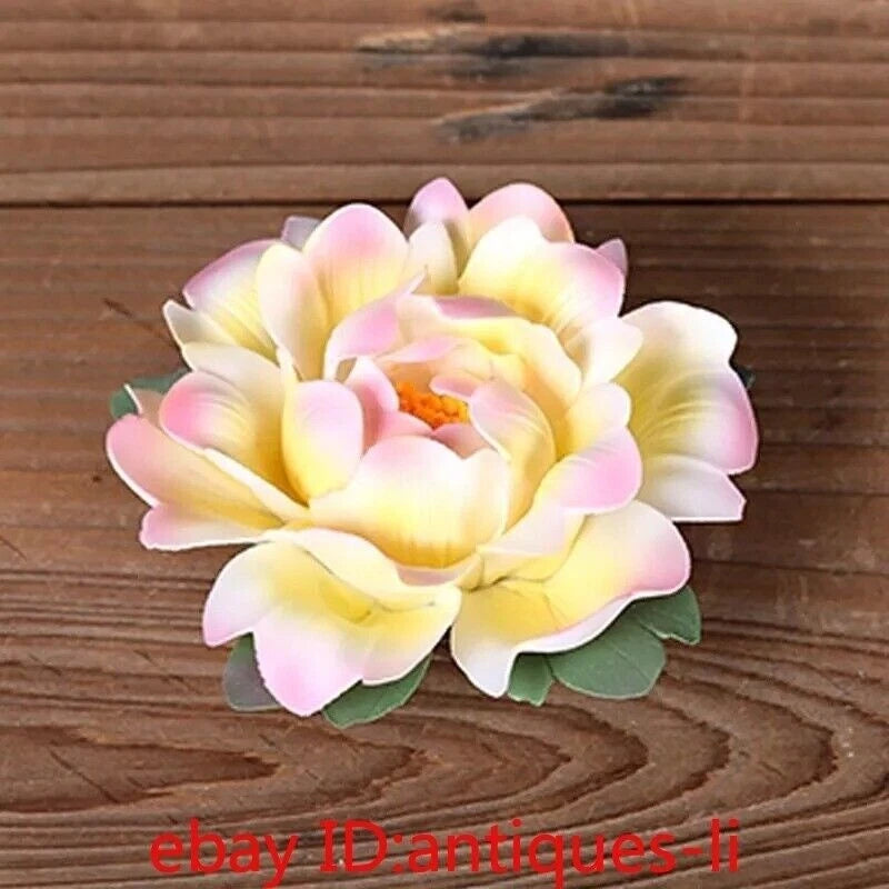 Pastel peony flower statue with layered petals and green leaf accents