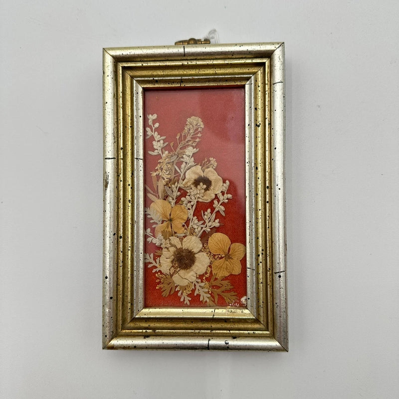 Framed pressed dried flower wall art with gold-toned frame and red floral mat