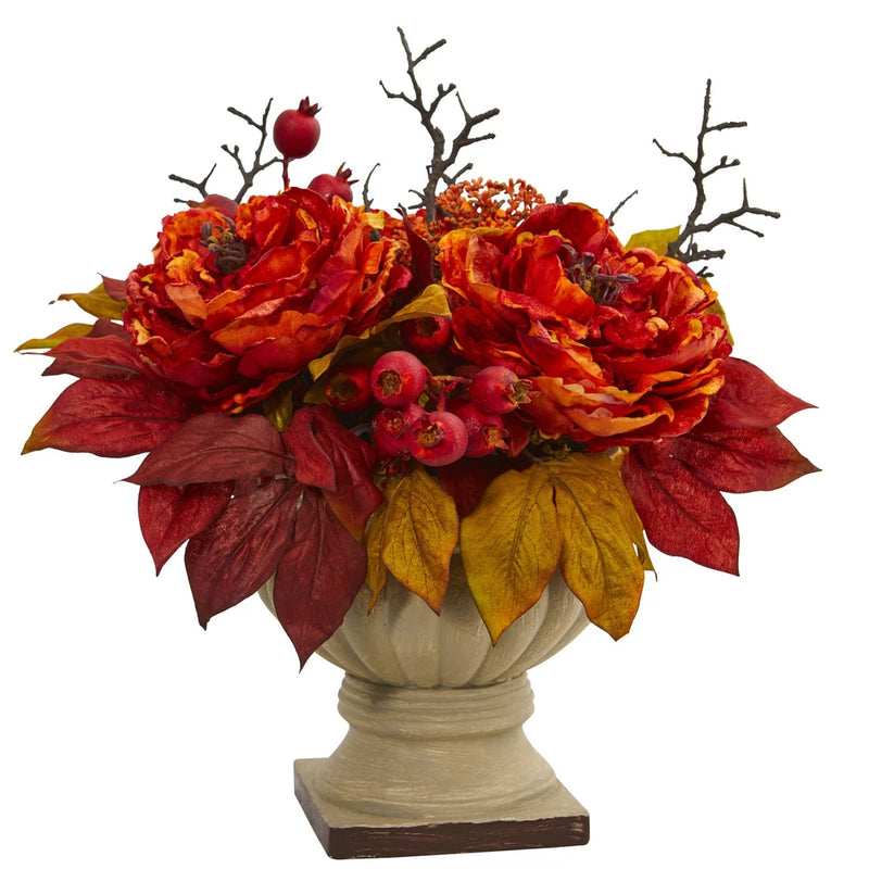 Artificial peony centerpiece with orange blooms, red berries, and leafy greens in vase