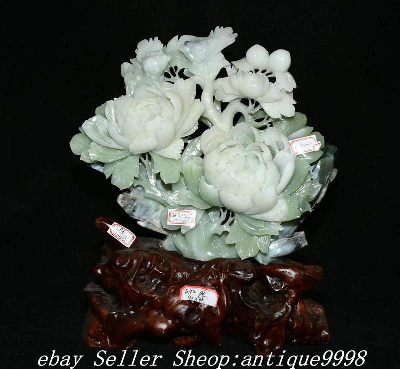 Carved jade peony flower and bird statue with blossoms on dark wooden base