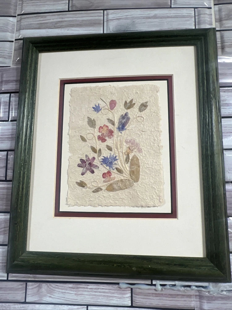 Framed pressed wildflower and leaf dried flower art with purple and blue blooms in dark green frame