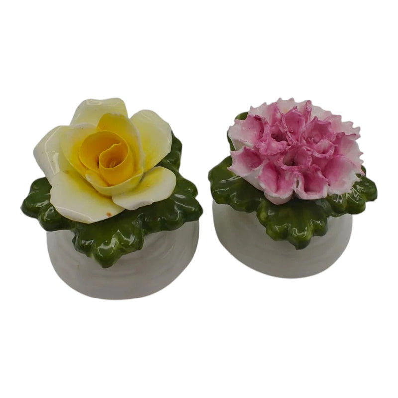 Flower-top salt and pepper shakers with white bases, yellow and pink blooms, green leaves