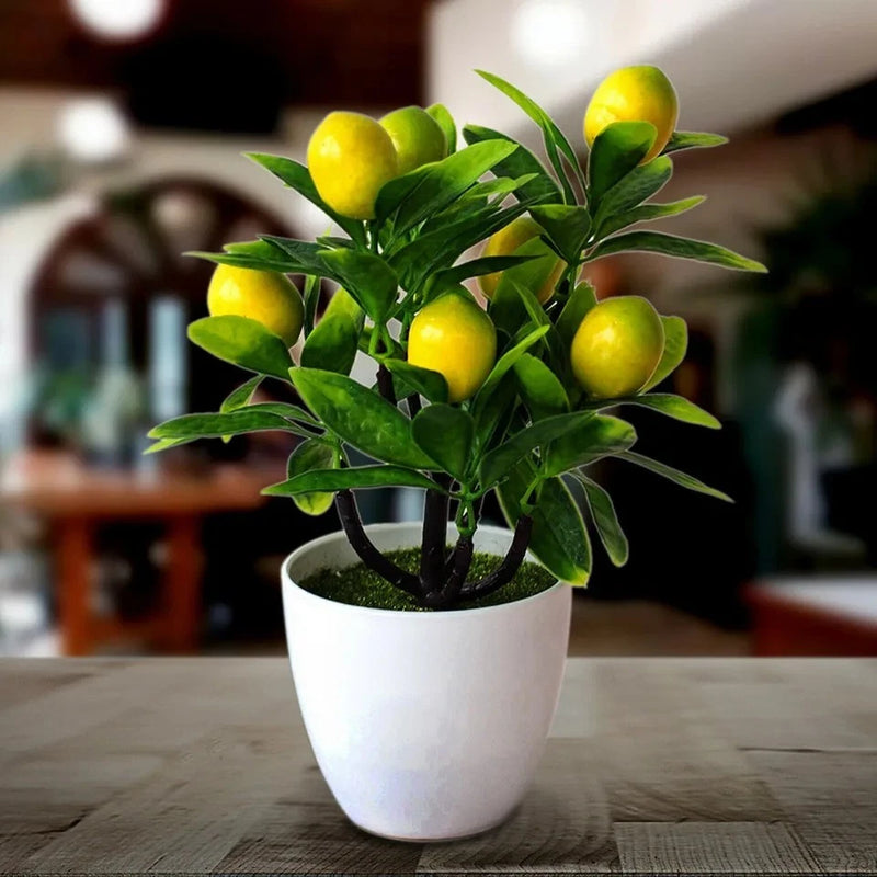Artificial lemon tree plant with yellow lemons and green leaves in white pot