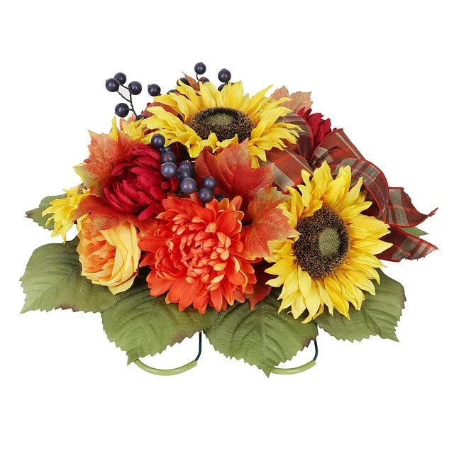 Memorial floral arrangement with yellow sunflowers, orange blooms, and plaid ribbon