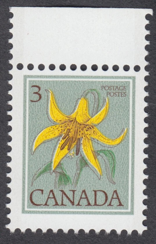 Canada postage stamp featuring a yellow Canada lily flower with “CANADA” lettering
