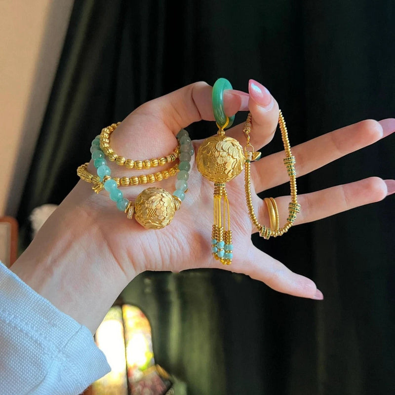Gold-tone necklace with peony-style pendants, turquoise bead accents, and dangling tassels