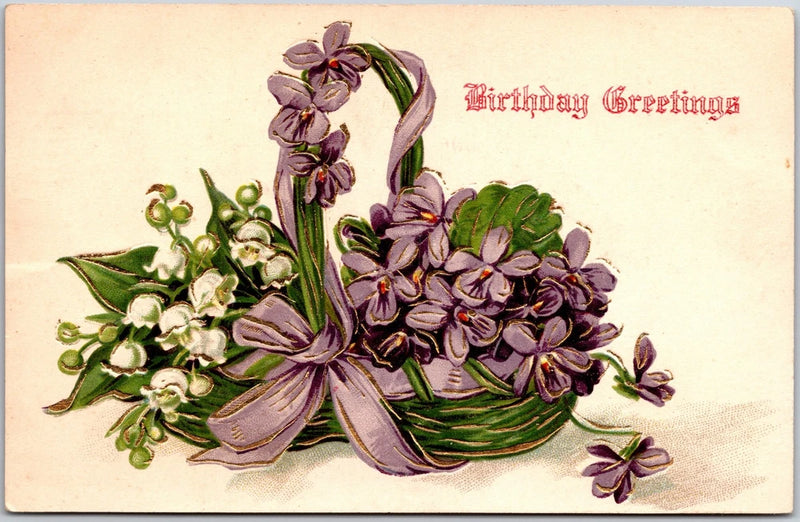Vintage floral greeting postcard with purple violets and lily-of-the-valley in a basket