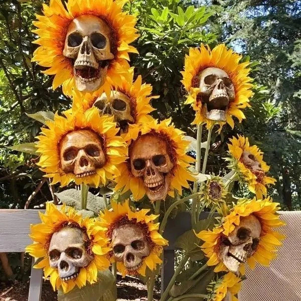 Skull and sunflower garden decor: yellow flower heads on stems with raised skull faces