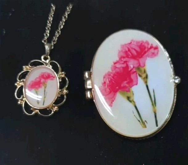 Gold-tone oval floral locket necklace with pink carnation, includes matching trinket box