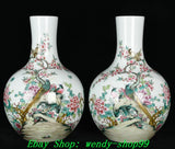 Pair of porcelain vases with peony, birds, and floral decoration on a white base