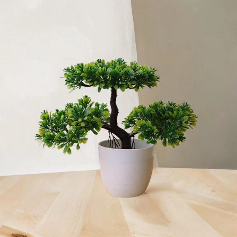 Artificial bonsai tree in white pot with green foliage