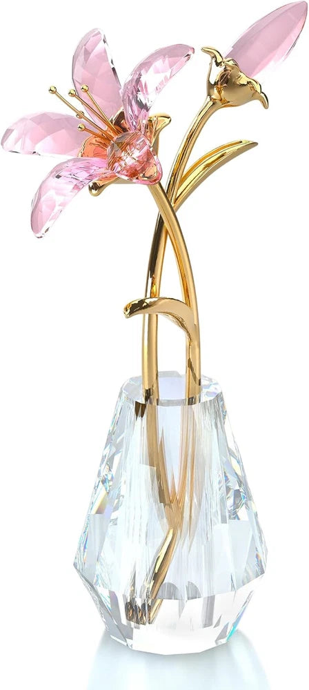 Crystal flower arrangement with pink lily petals on gold metal stems and a clear faceted vase