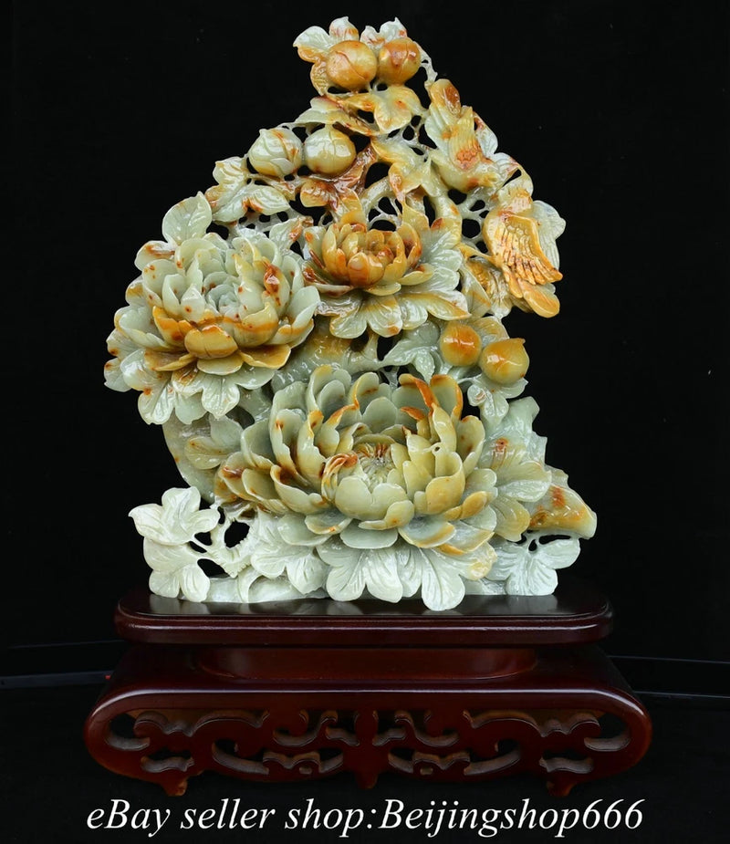 Carved pale jade peony and bird sculpture with layered blooms on dark wooden base