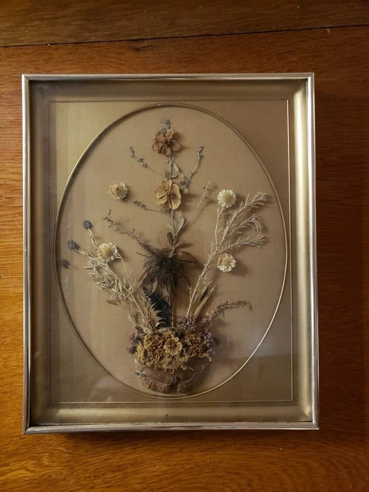 Vintage framed dried flower arrangement with oval glass and beige-brown dried blooms