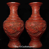 Pair of red lacquer peony vases, embossed floral relief and rounded bottle shape.