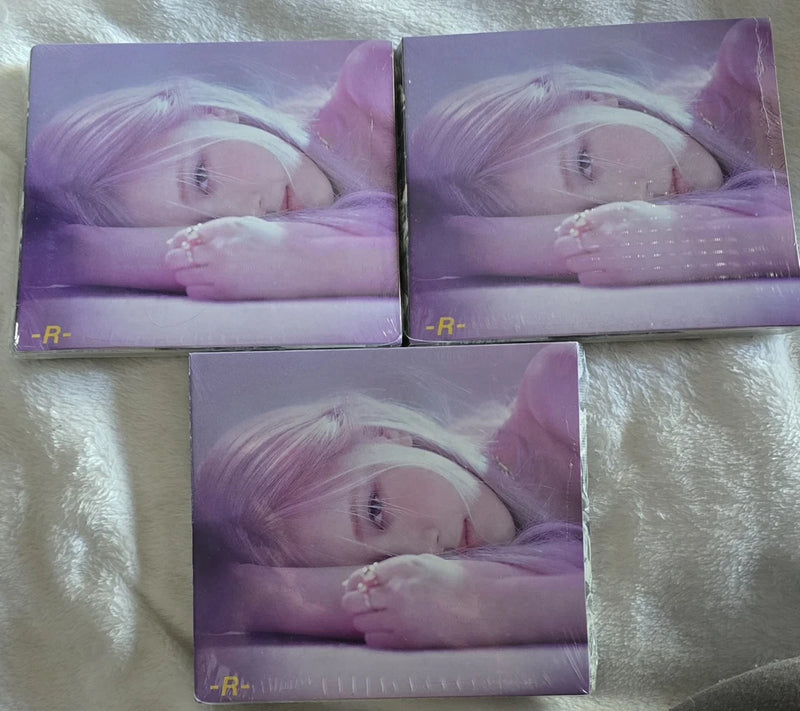 Sealed K-pop CD album set of three with purple cover and close-up portrait