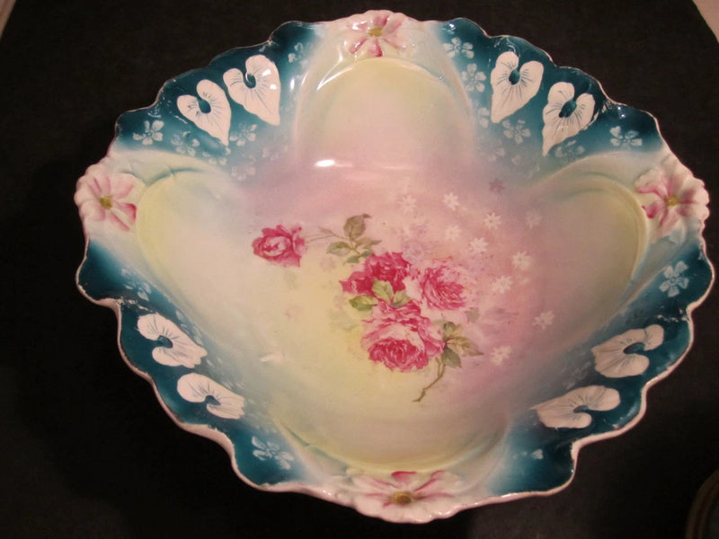 Scalloped porcelain bowl with blue rim and pink carnation and rose floral design