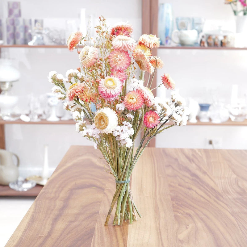 Dried flower bouquet with pink, peach, and white blooms and slender stems