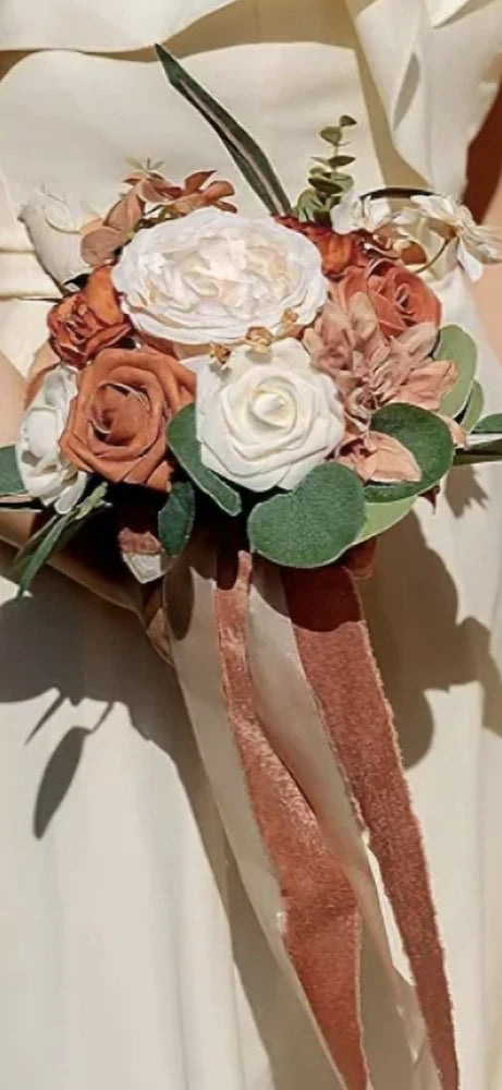 Bencentre fall bridesmaid bouquet with rust orange, cream roses, pink blooms, and dusty rose ribbon