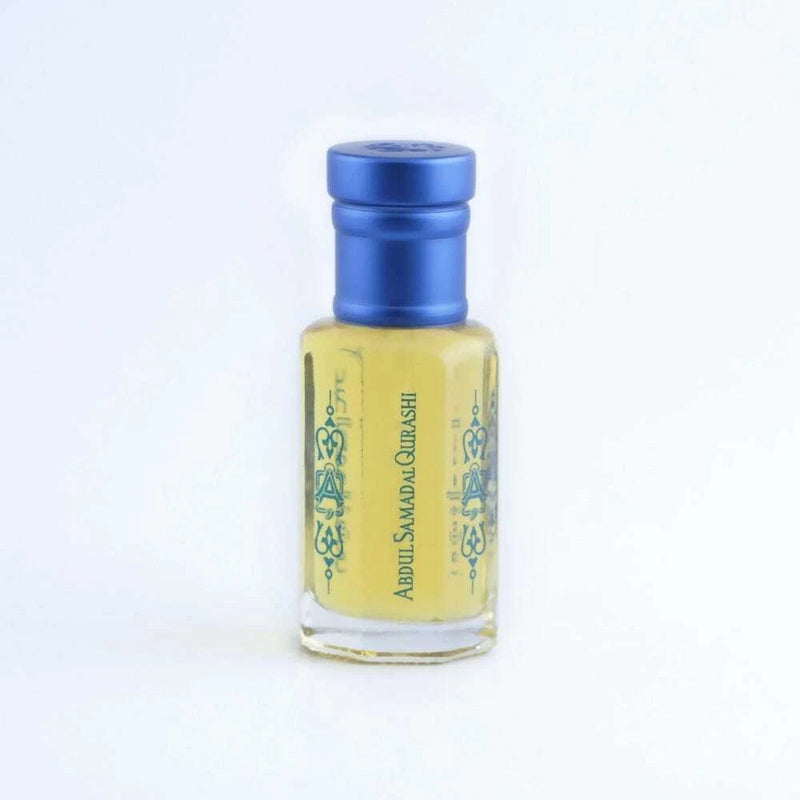 Abdul Samad Al Qurashi attar oil bottle with blue cap and pale yellow liquid