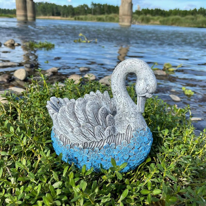 Gray swan-shaped flowerpot with blue floral base for garden plants
