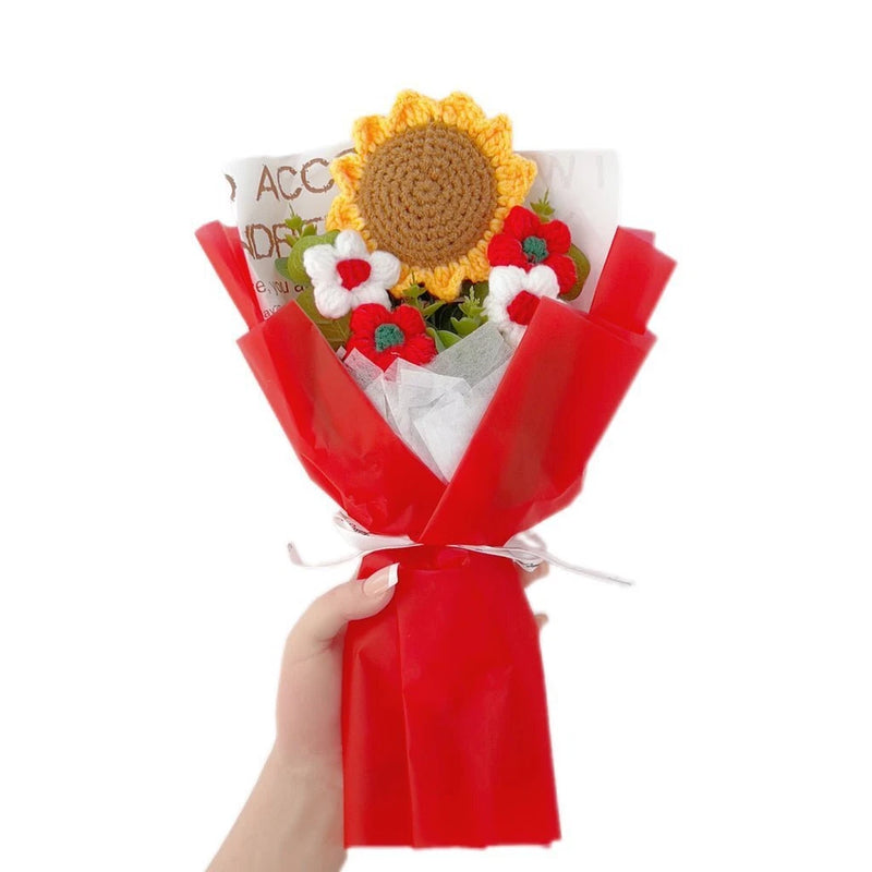 Crochet sunflower bouquet with yellow flower, red wrapping, and small green and red blossoms